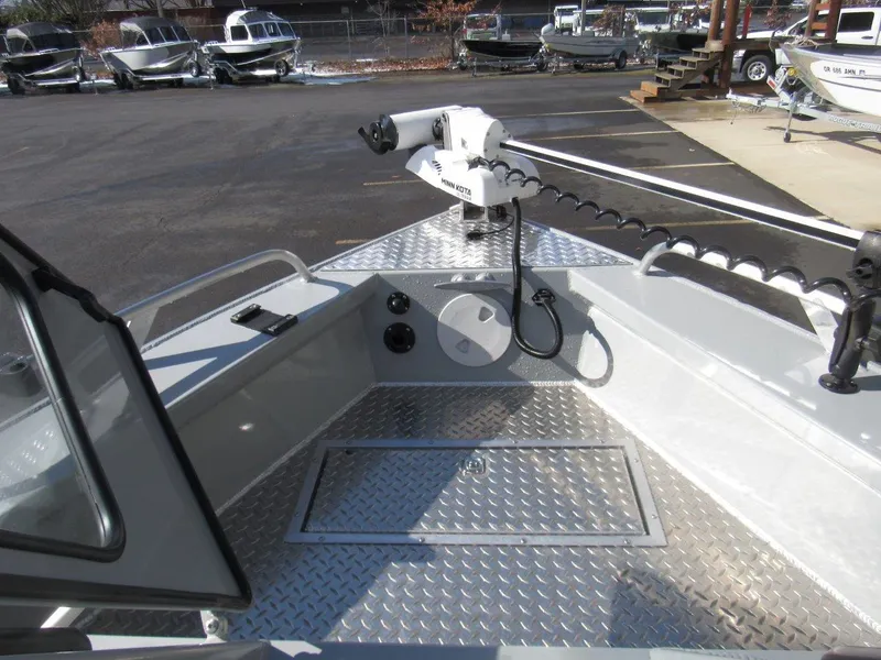 Slide: The Image of 2023 Hewescraft 210 Sea Runner ET boat deck with trolling motor and diamond plate flooring. - 16