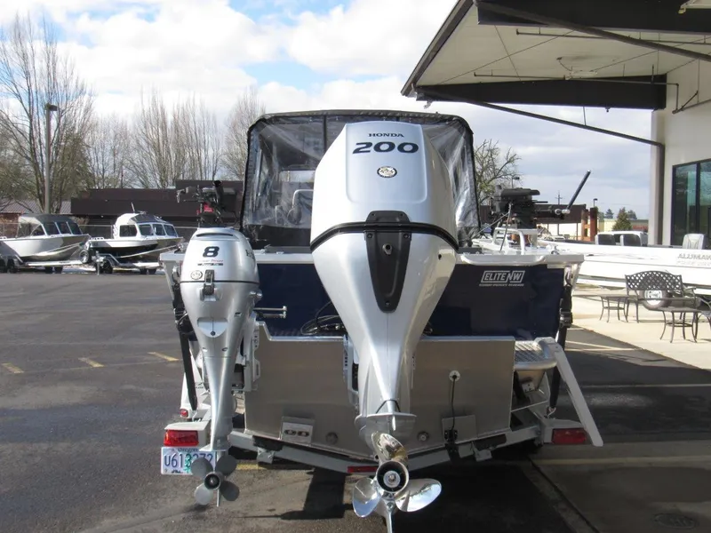 Slide: The Image of 2023 Hewescraft 210 Sea Runner ET with dual Honda outboard motors, parked outdoors. - 4