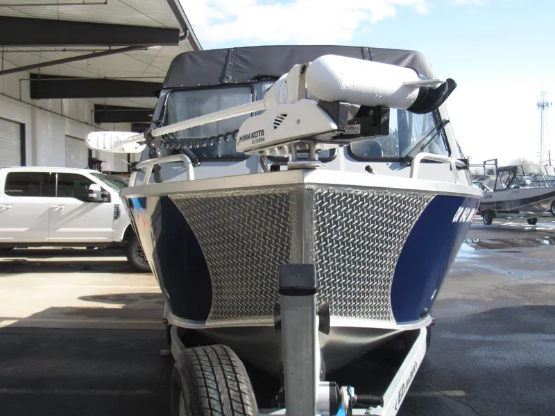 Slide: The Image of 2023 Hewescraft 210 Sea Runner ET boat with Minn Kota motor, parked outdoors. - 8