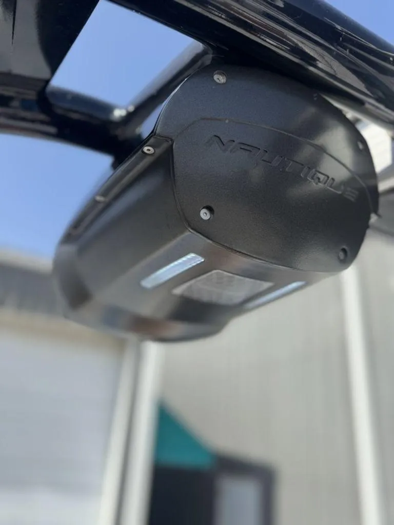 Slide: The Image of Close-up of a 2015 Nautique G21 boat speaker under a sunny sky. - 12