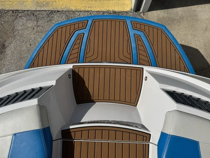 Slide: The Image of 2015 Nautique G21 boat deck with brown and blue accents. - 14