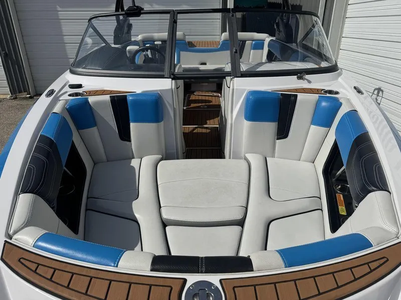 Slide: The Image of 2015 Nautique G21 boat interior with blue and white seating, wood accents. - 3