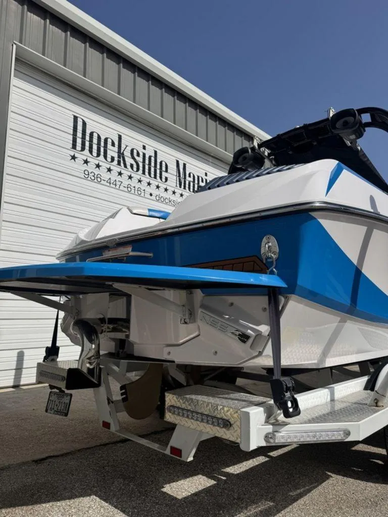 Slide: The Image of 2015 Nautique G21 boat at Dockside Marine, featuring blue and white design. - 4