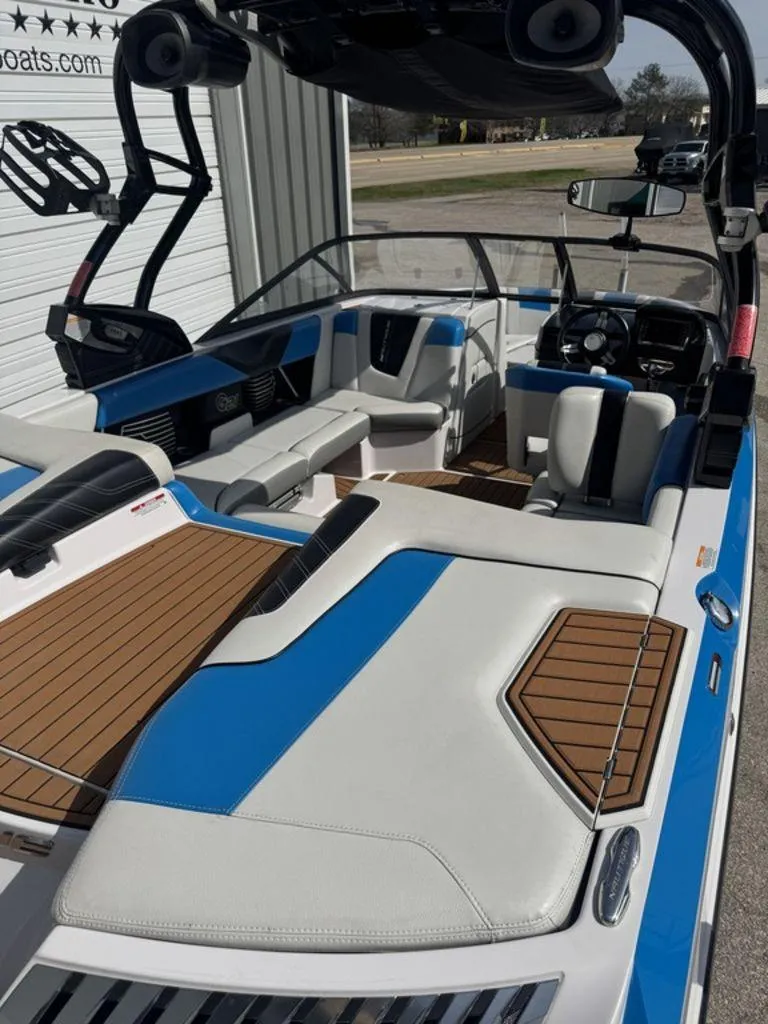 Slide: The Image of 2015 Nautique G21 boat interior with blue and white seating, wood accents, and modern design. - 5