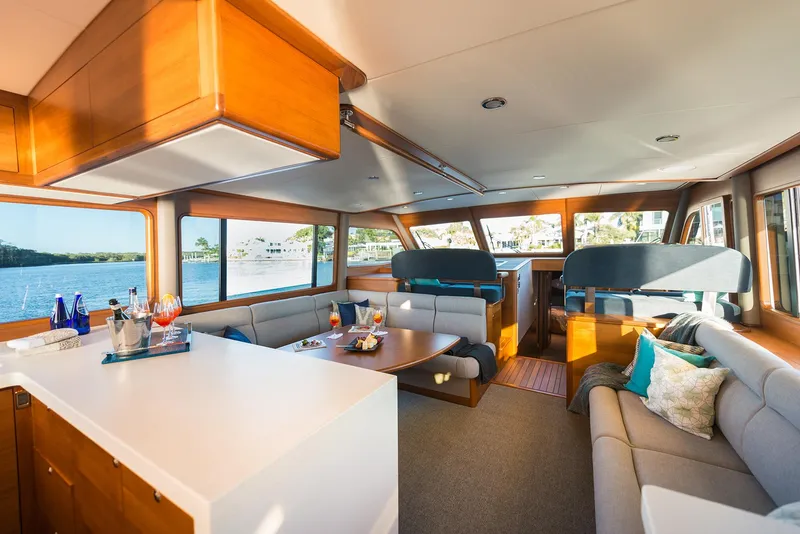 Slide: The Image of Luxurious interior of 2026 Grand Banks GB 60 yacht with modern seating and panoramic windows. - 27