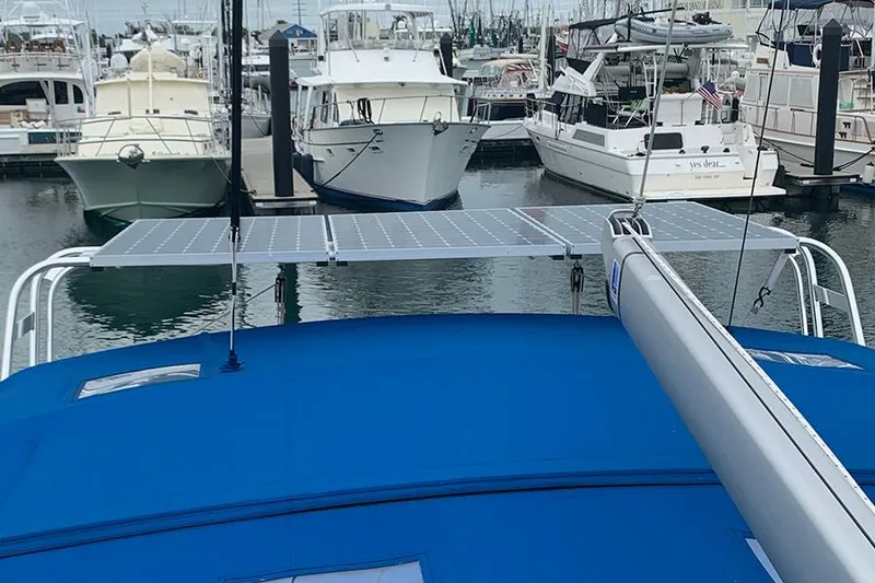 Slide: The Image of 2019 Jeanneau Sun Odyssey 490 with solar panels docked at a marina. - 18