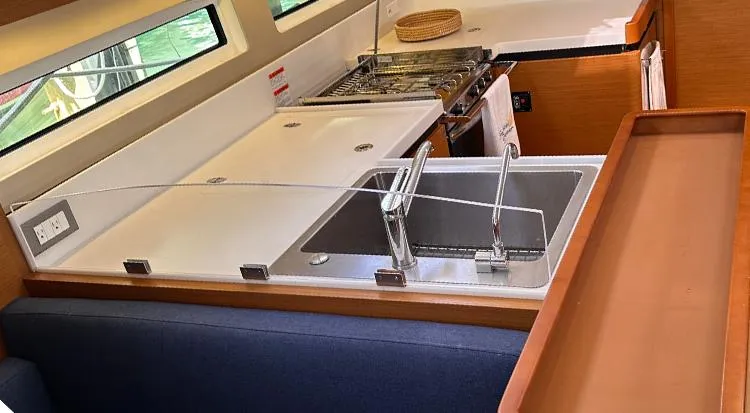 Slide: The Image of Interior of 2019 Jeanneau Sun Odyssey 490 yacht kitchen with sink and stove. - 21