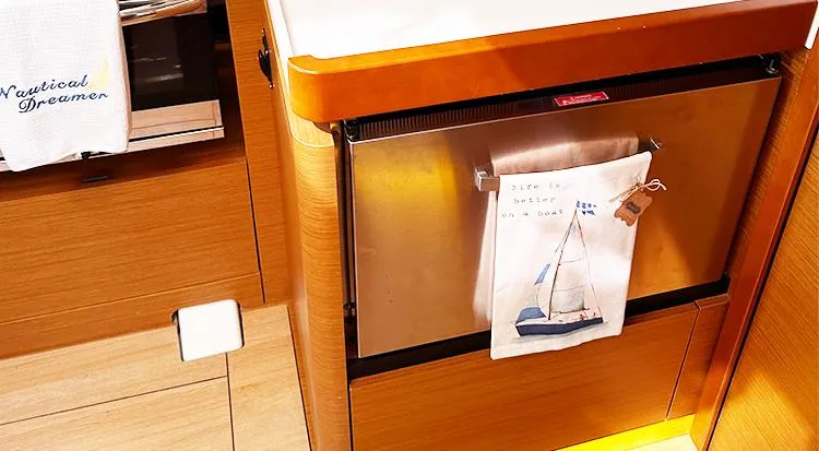 Slide: The Image of Interior of 2019 Jeanneau Sun Odyssey 490 yacht kitchen with nautical-themed decor. - 24