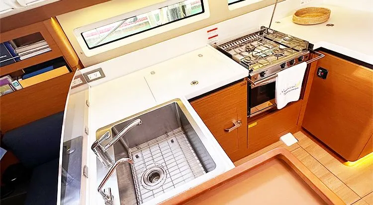 Slide: The Image of Modern kitchen in 2019 Jeanneau Sun Odyssey 490 yacht with sink and stove. - 25