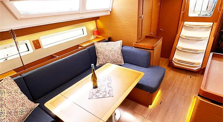 Slide: The Image of Interior of 2019 Jeanneau Sun Odyssey 490 yacht with cozy seating and elegant table setting. - 29