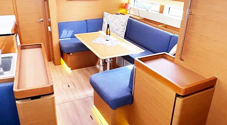 Slide: The Image of Interior of 2019 Jeanneau Sun Odyssey 490 yacht with blue seating and wooden finishes. - 30