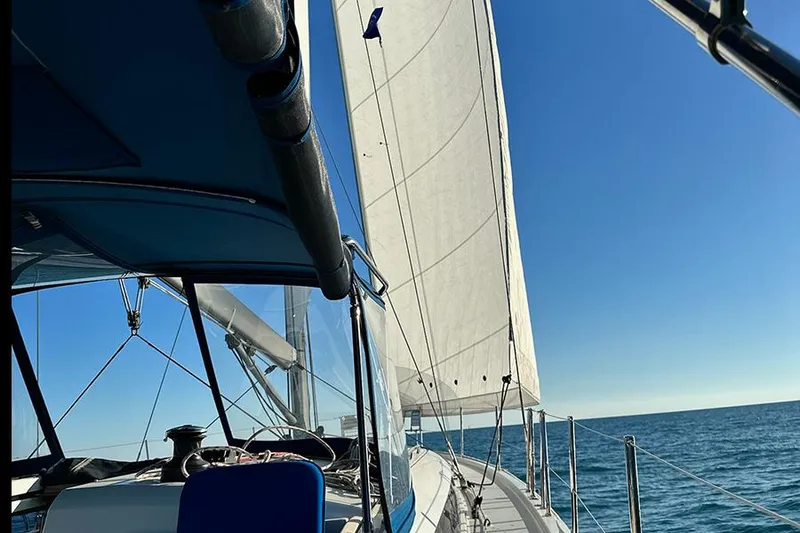 Slide: The Image of Jeanneau Sun Odyssey 490 sailing on open sea under clear blue sky, 2019 model. - 5