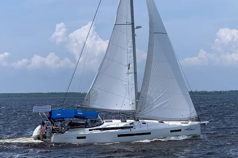 Slide: The Image of 2019 Jeanneau Sun Odyssey 490 sailing on open water under clear skies. - 6