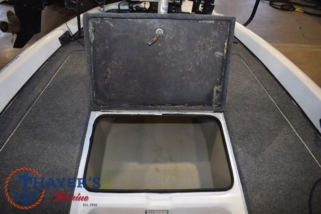 Slide: The Image of 1997 ProCraft 180 boat storage compartment with open hatch, carpeted interior. - 10