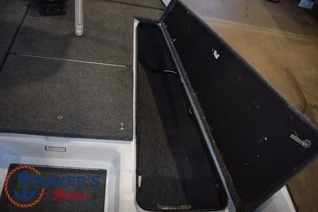 Slide: The Image of 1997 ProCraft 180 boat storage compartment with open lid, showcasing interior space. - 11