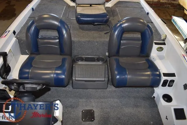 Slide: The Image of 1997 ProCraft 180 boat interior with blue and gray seating and center console. - 13