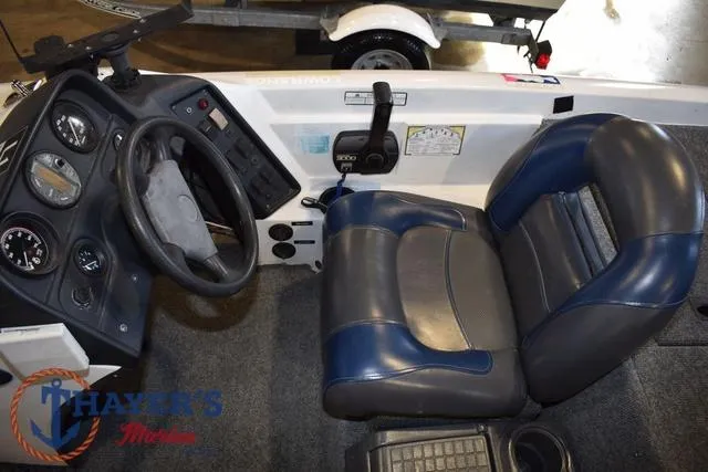 Slide: The Image of 1997 ProCraft 180 boat interior with steering wheel, gauges, and blue-gray seating. - 14