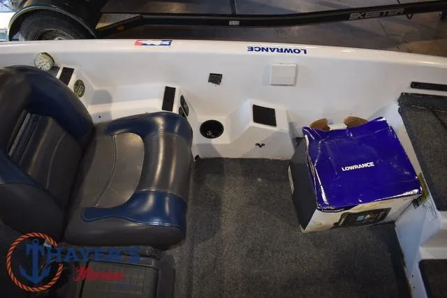 Slide: The Image of 1997 ProCraft 180 boat interior with blue seating and Lowrance equipment box. - 15