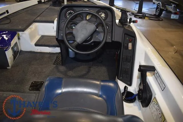Slide: The Image of Interior of a 1997 ProCraft 180 boat showing steering wheel and dashboard controls. - 16