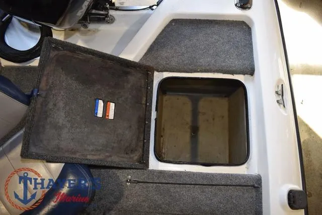 Slide: The Image of Open storage compartment in 1997 ProCraft 180 boat, featuring carpeted interior and visible branding. - 19