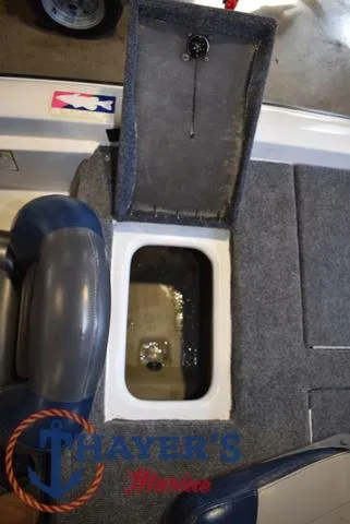 Slide: The Image of Open storage compartment in a 1997 ProCraft 180 boat with gray carpet interior. - 20