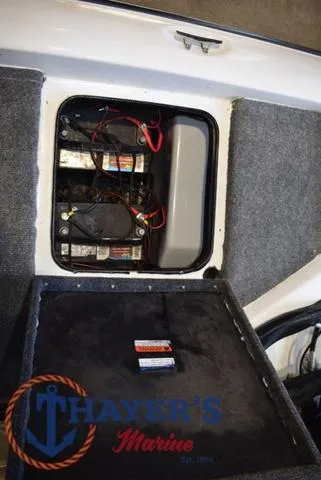 Slide: The Image of Battery compartment of a 1997 ProCraft 180 boat, featuring multiple batteries and wiring. - 21