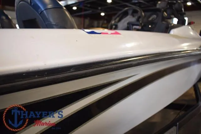 Slide: The Image of 1997 ProCraft 180 boat side view with sleek design and Thayer's Marine logo. - 25