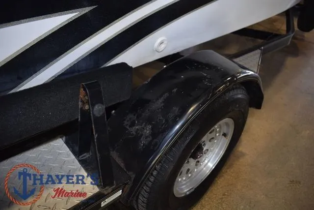 Slide: The Image of Trailer of a 1997 ProCraft 180 boat, featuring a black fender and Thayer's Marine logo. - 26