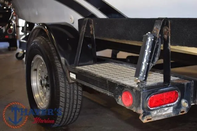Slide: The Image of Trailer of a 1997 ProCraft 180 boat with visible taillight and tire. - 28