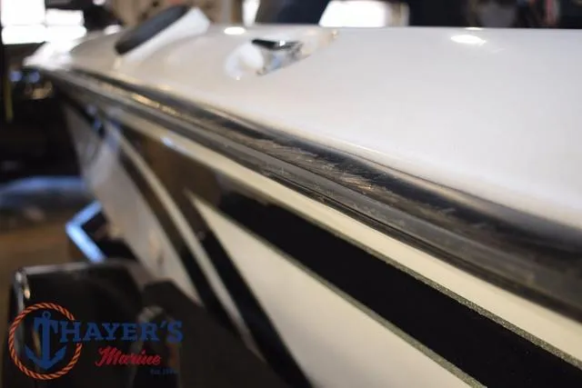 Slide: The Image of 1997 ProCraft 180 boat side view, featuring sleek white and black design. - 29