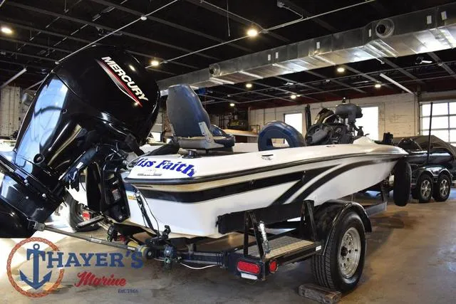 Slide: The Image of 1997 ProCraft 180 boat with Mercury engine in showroom, featuring Thayer's Marine logo. - 3