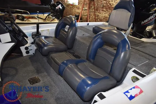 Slide: The Image of 1997 ProCraft 180 boat interior with blue and gray seating, featuring a Mercury engine. - 31