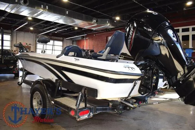 Slide: The Image of 1997 ProCraft 180 boat with Mercury outboard motor in a showroom. - 4