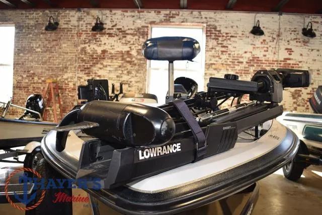 Slide: The Image of 1997 ProCraft 180 boat with Lowrance equipment in a brick-walled showroom. - 5