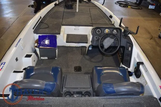 Slide: The Image of 1997 ProCraft 180 boat interior with steering wheel, seats, and dashboard in a garage setting. - 7