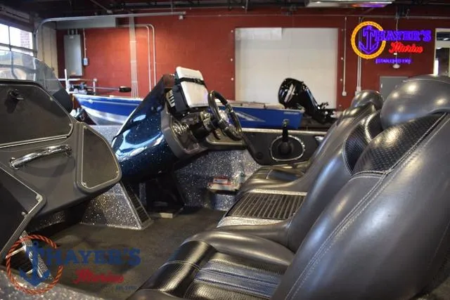 Slide: The Image of 2011 Ranger Z520C boat interior with black leather seats and modern dashboard. - 10
