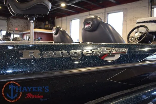 Slide: The Image of 2011 Ranger Z520C boat interior with logo, Thayer's Marine branding visible. - 12