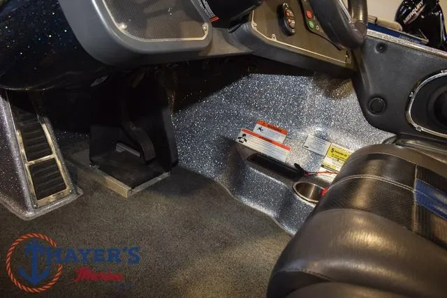 Slide: The Image of Interior of a 2011 Ranger Z520C boat, featuring steering controls and seating area. - 19