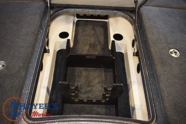 Slide: The Image of 2011 Ranger Z520C boat storage compartment with carpeted interior and secure latches. - 23