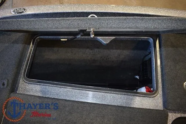 Slide: The Image of Open storage compartment in a 2011 Ranger Z520C boat, featuring Thayer's Marine logo. - 25