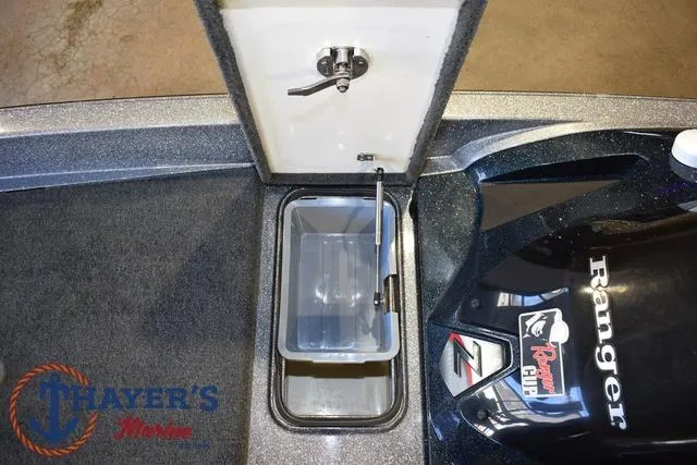 Slide: The Image of Ranger Z520C 2011 boat storage compartment with open lid and visible interior. - 26