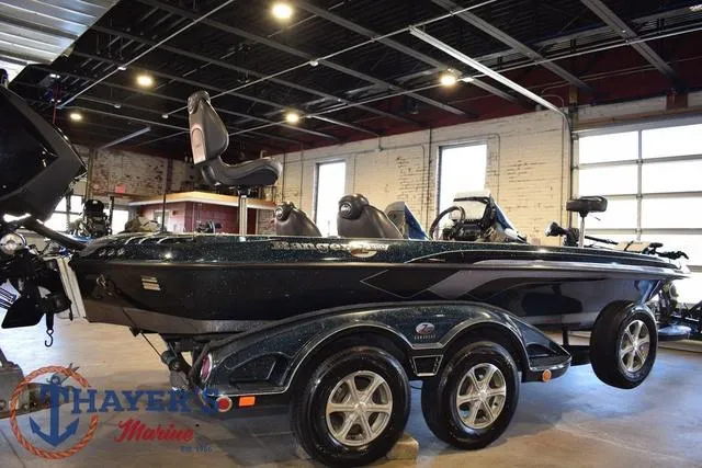 Slide: The Image of 2011 Ranger Z520C boat in showroom, featuring dual-axle trailer and sleek design. - 3