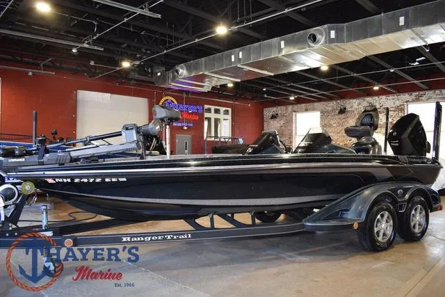 Slide: The Image of 2011 Ranger Z520C boat displayed indoors at Thayer's Marine showroom. - 6