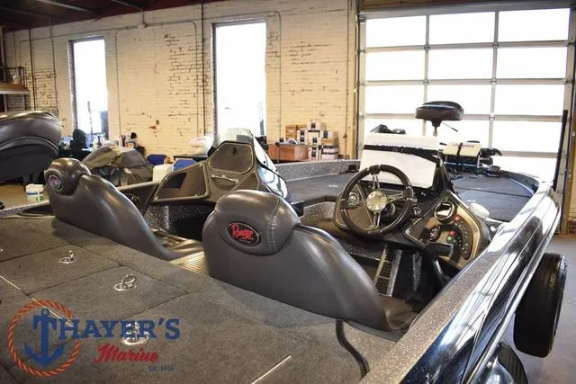 Slide: The Image of 2011 Ranger Z520C boat interior with dual seats and steering wheel in a garage setting. - 8