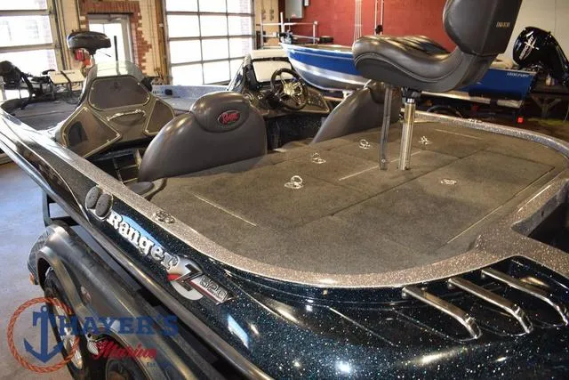 Slide: The Image of 2011 Ranger Z520C bass boat interior with seating and storage compartments. - 9