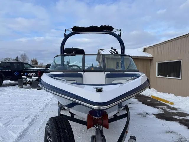 Slide: The Image of 2015 Nautique 200 boat on trailer in snowy outdoor setting. - 10