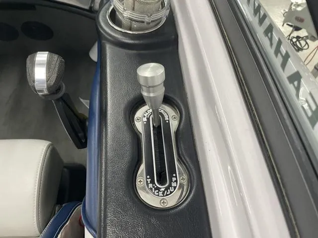 Slide: The Image of Throttle control of 2015 Nautique 200 boat, featuring sleek design and metallic finish. - 14