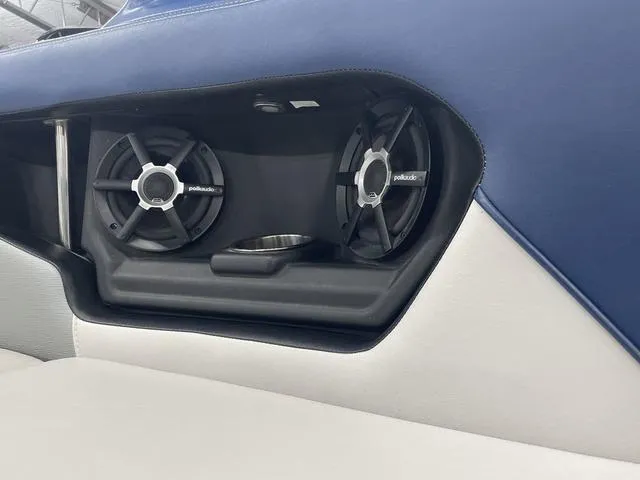 Slide: The Image of 2015 Nautique 200 boat interior with Polk Audio speakers and cup holder. - 16