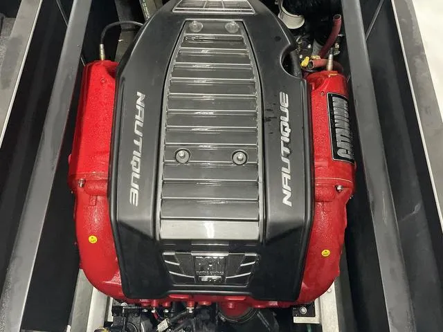 Slide: The Image of Engine of 2015 Nautique 200 boat with red and black components. - 17