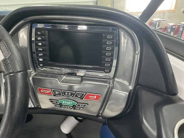 Slide: The Image of Dashboard of a 2015 Nautique 200 boat with control panel and display screen. - 9